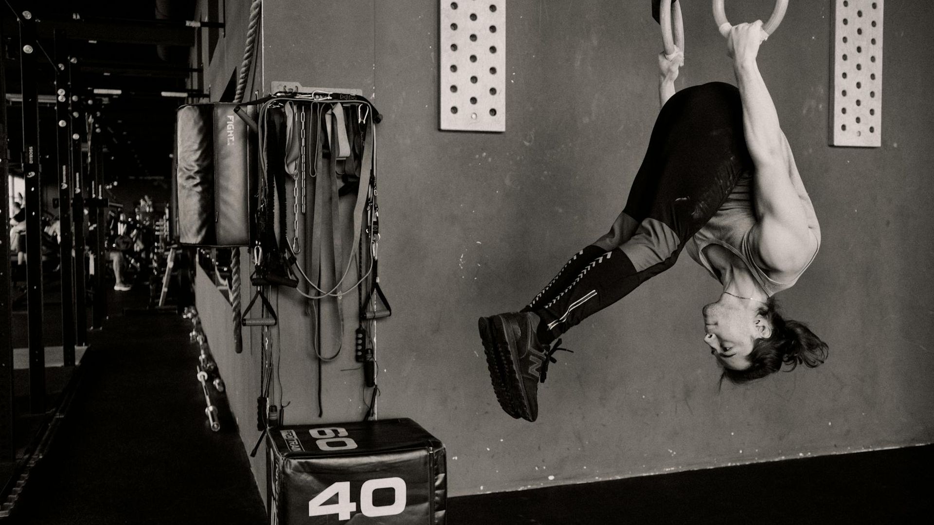 Athletic man performing strength exercises in a minimalist industrial gym
