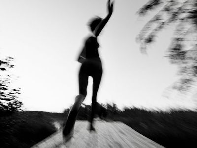 Blurry motion of an athlete running in a park