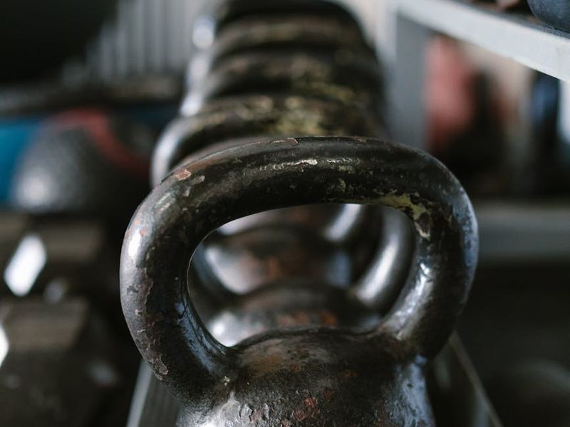 Detailed shot of a heavy steel kettlebell on gym floor